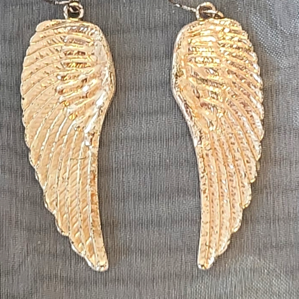 Gold angel wing earrings.